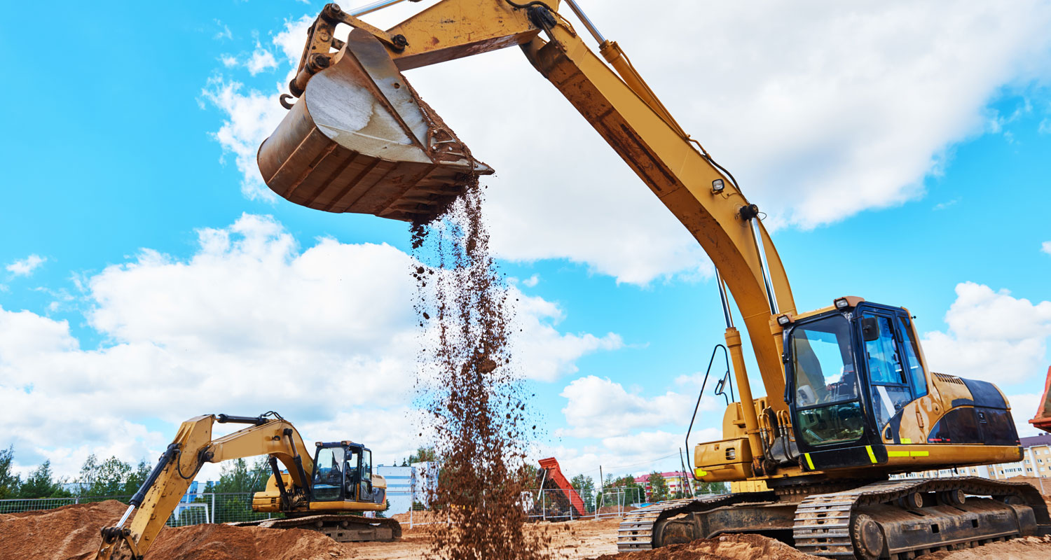 A large digger excavates a construction site